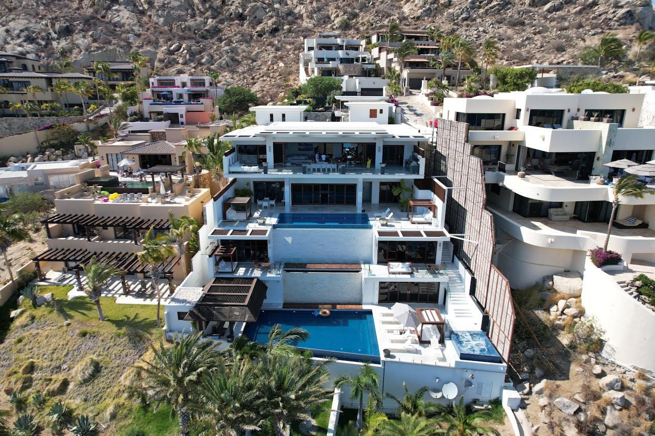 Aerial view of stunning modern villas in Cabo San Lucas with ocean views.